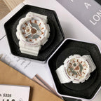 Casio watch in black display box with white resin strap and gold-toned multi-dial face