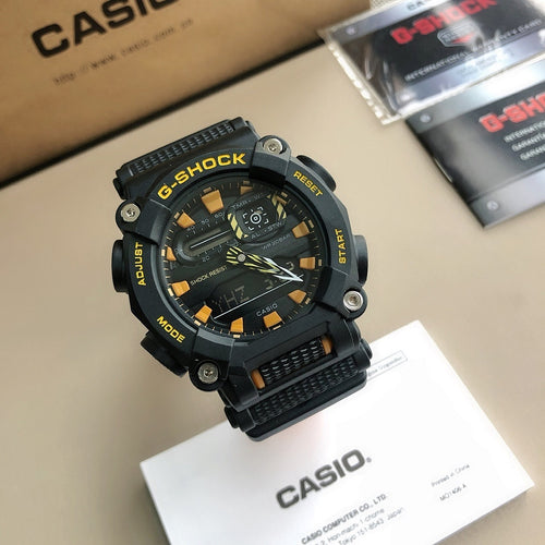Casio G-Shock digital watch with black and orange resin strap, dark round face.