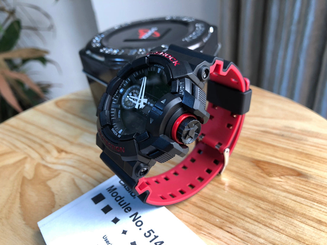 Casio G-Shock watch side view, red strap and black case with buttons