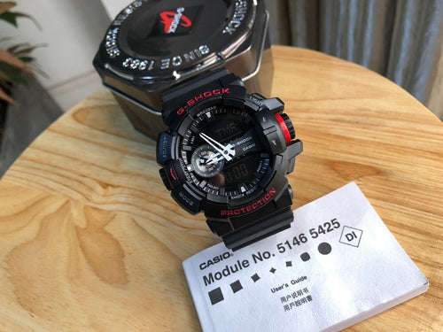 Casio G-Shock watch with black resin strap, red accents, round analog-digital face