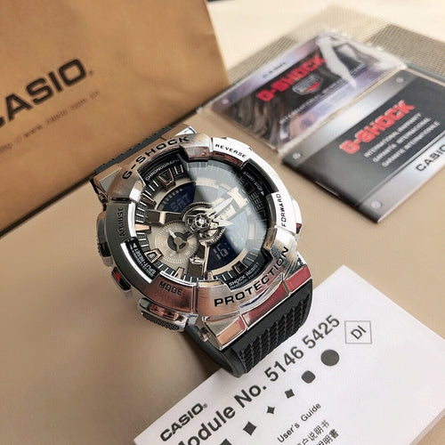 Casio G-Shock style wristwatch with black rubber strap and silver bezel, blue dial