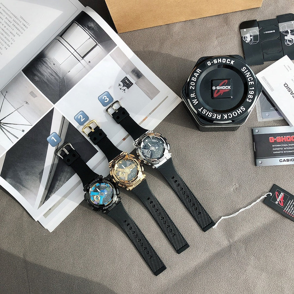 Casio watches with black straps, silver-blue and gold faces arranged on a surface