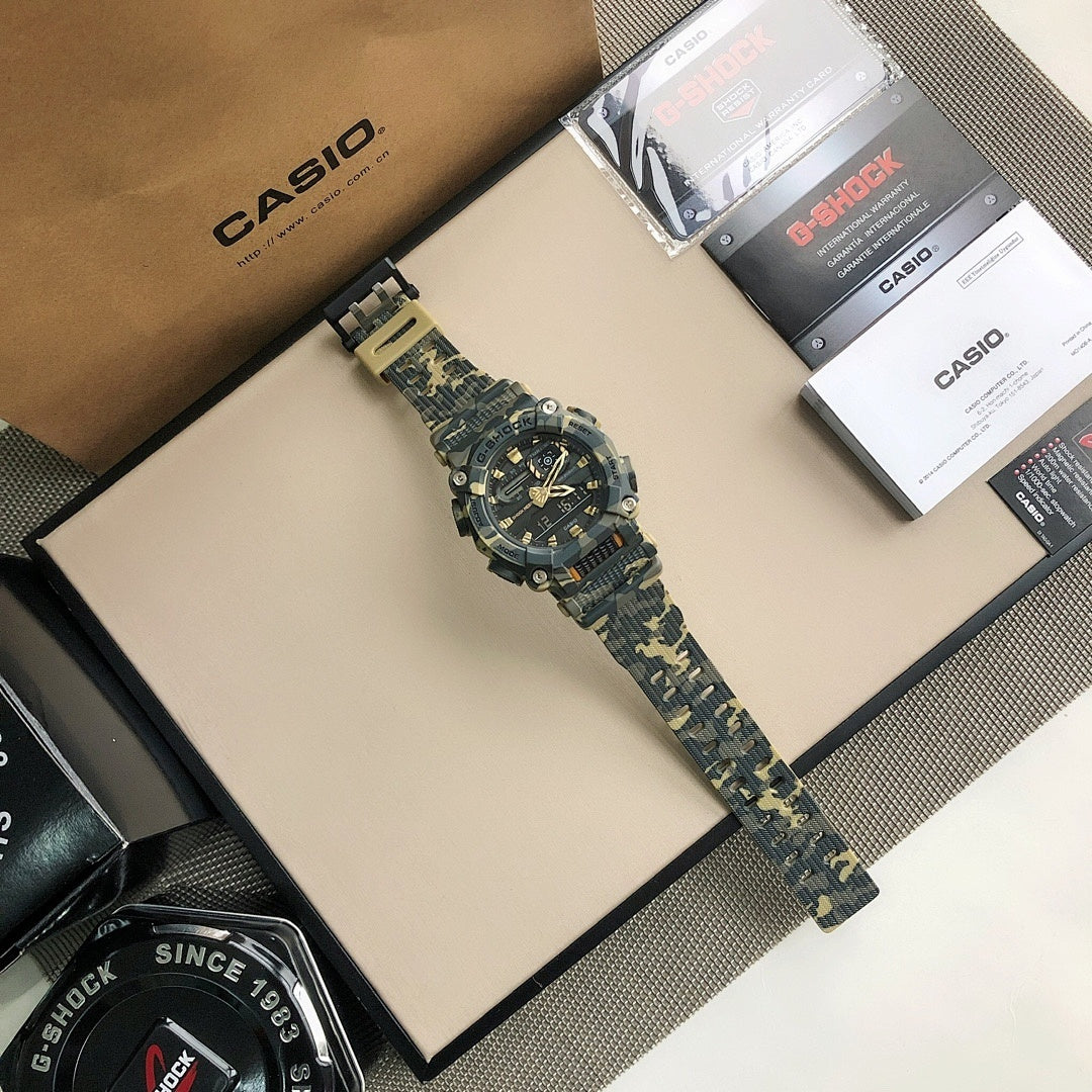 G-Shock style wristwatch with blue camo strap and black dial with gold hands