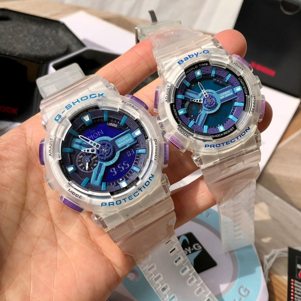 Casio watches held in hand, clear resin cases with blue dials and purple details