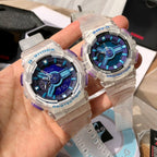 Casio watches held in hand, clear resin cases with blue dials and purple details