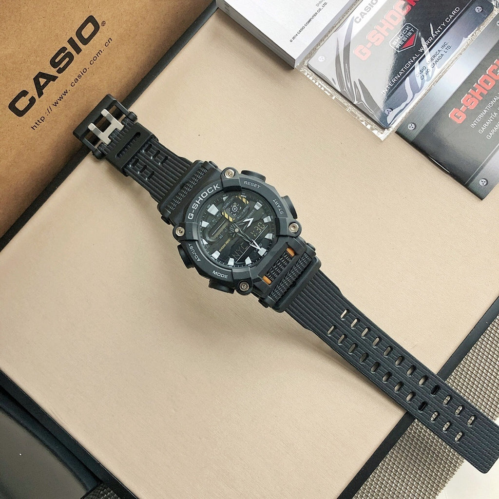 Casio G-Shock-style digital watch with black resin strap featuring perforated holes