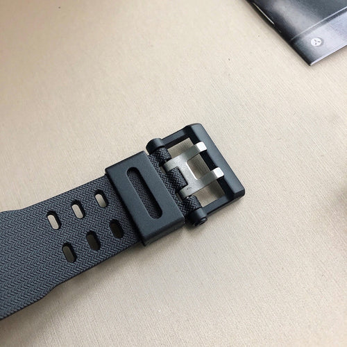 Casio watch strap buckle in dark gray resin with textured band and strap holes
