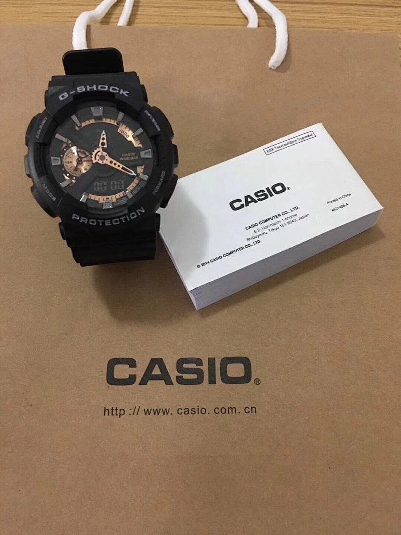 G-Shock watch with black resin strap and black dial, gold details.