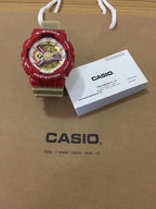 G-Shock watch with red resin strap and gold dial, multiple subdials.