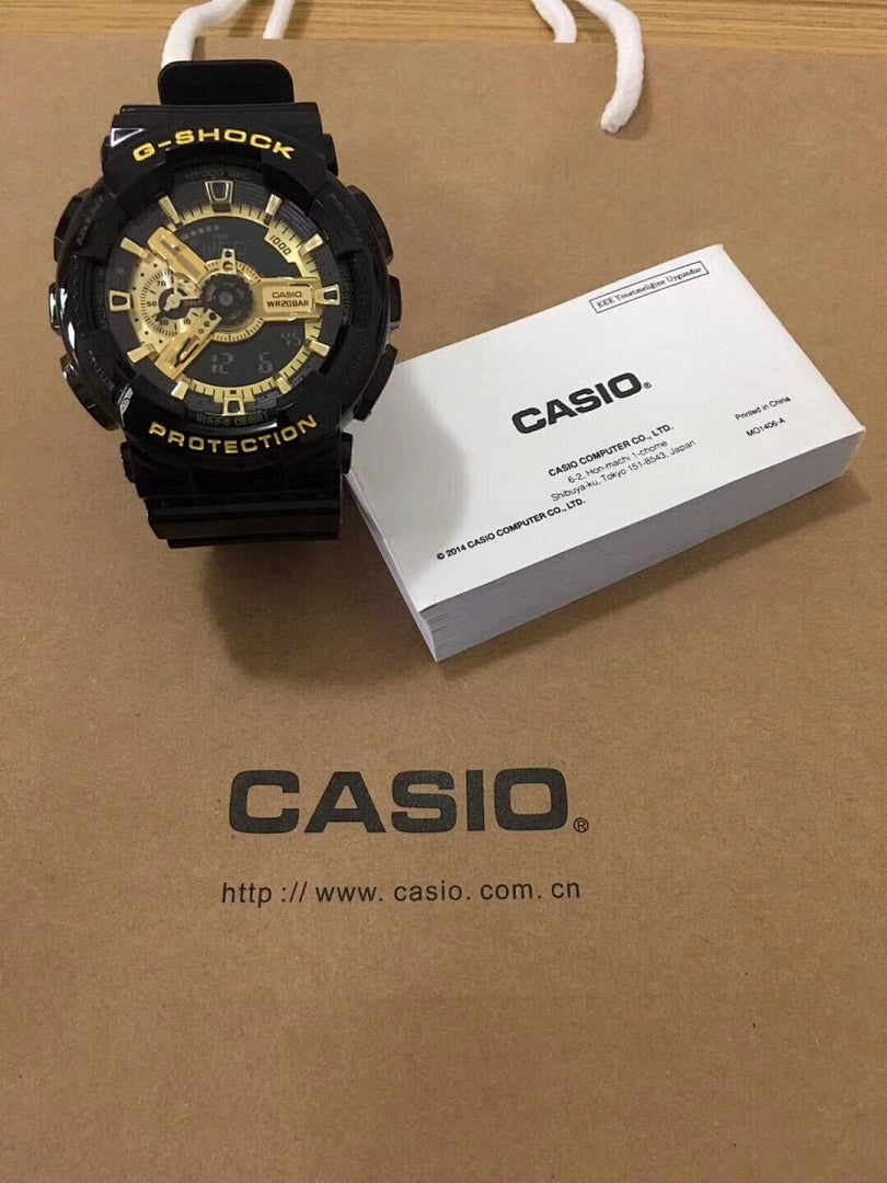 G-Shock watch with black resin strap and gold dial, gold-tone hands.