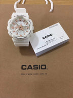 G-Shock watch with white resin strap and light dial with bronze accents.