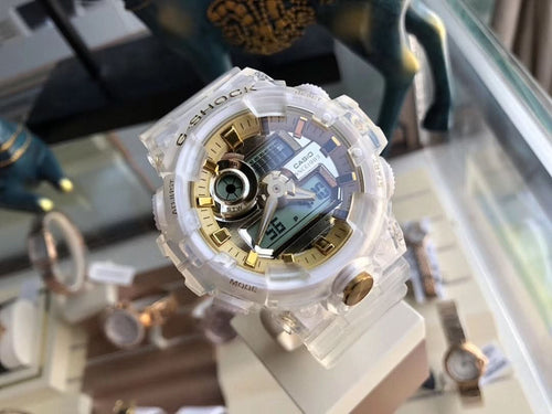 Casio watch with white translucent case and gold-tone bezel accents