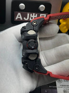 Casio G-Shock wristwatch side controls on black case with red strap