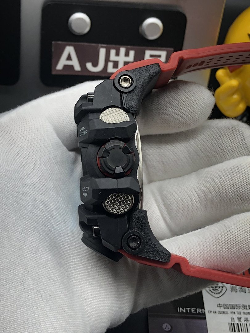 Casio G-Shock wristwatch side controls on black case with red strap