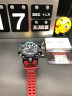 Casio G-Shock wristwatch with black case and red rubber strap, angled view
