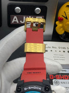 Casio G-Shock wristwatch clasp and strap ends in gold-tone and red