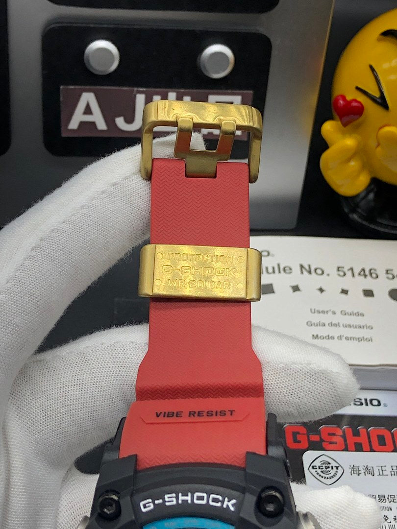 Casio G-Shock wristwatch clasp and strap ends in gold-tone and red