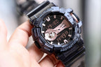 Casio G-Shock watch with black strap and dark dial, rose-gold details, subdial at center