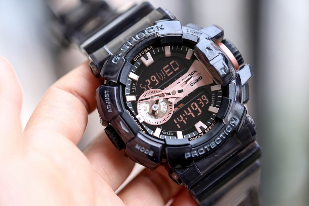 Casio G-Shock watch with black strap and dark dial, rose-gold details, subdial at center