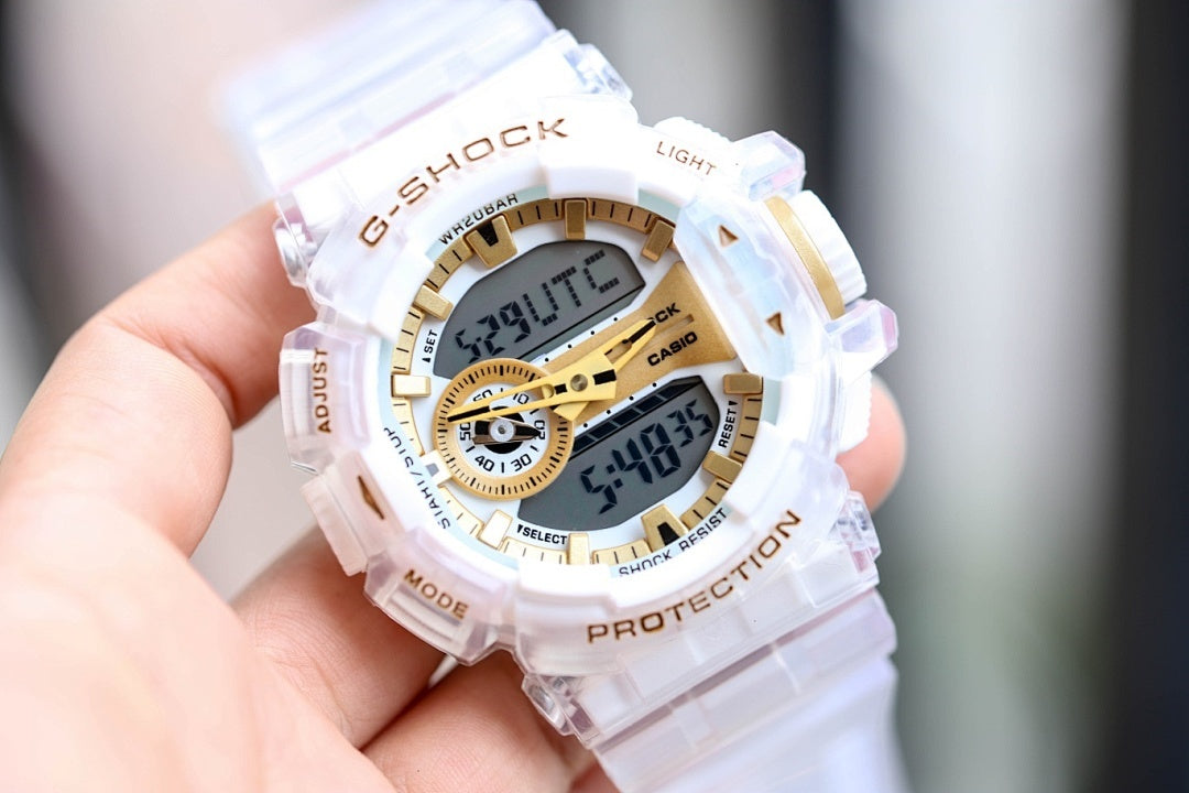 Casio G-Shock watch with translucent white strap and gold dial, bezel markings and digital readout