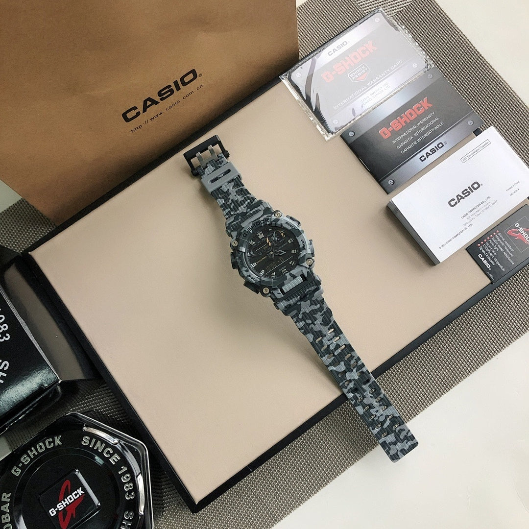 G-Shock camo sport watch lying flat, black dial and gray camo resin strap