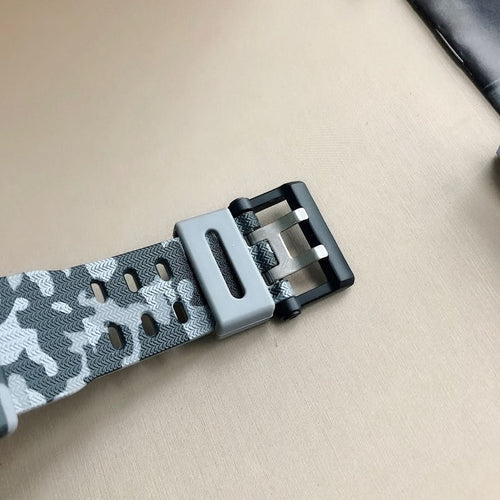 G-Shock camo watch strap with gray buckle clasp and perforated resin band