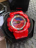 Red Casio G-Shock wristwatch, colorful dial and PROTECTION bezel on cushion