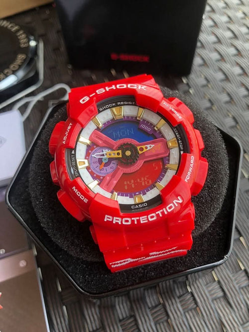 Red Casio G-Shock wristwatch, colorful dial and PROTECTION bezel on cushion