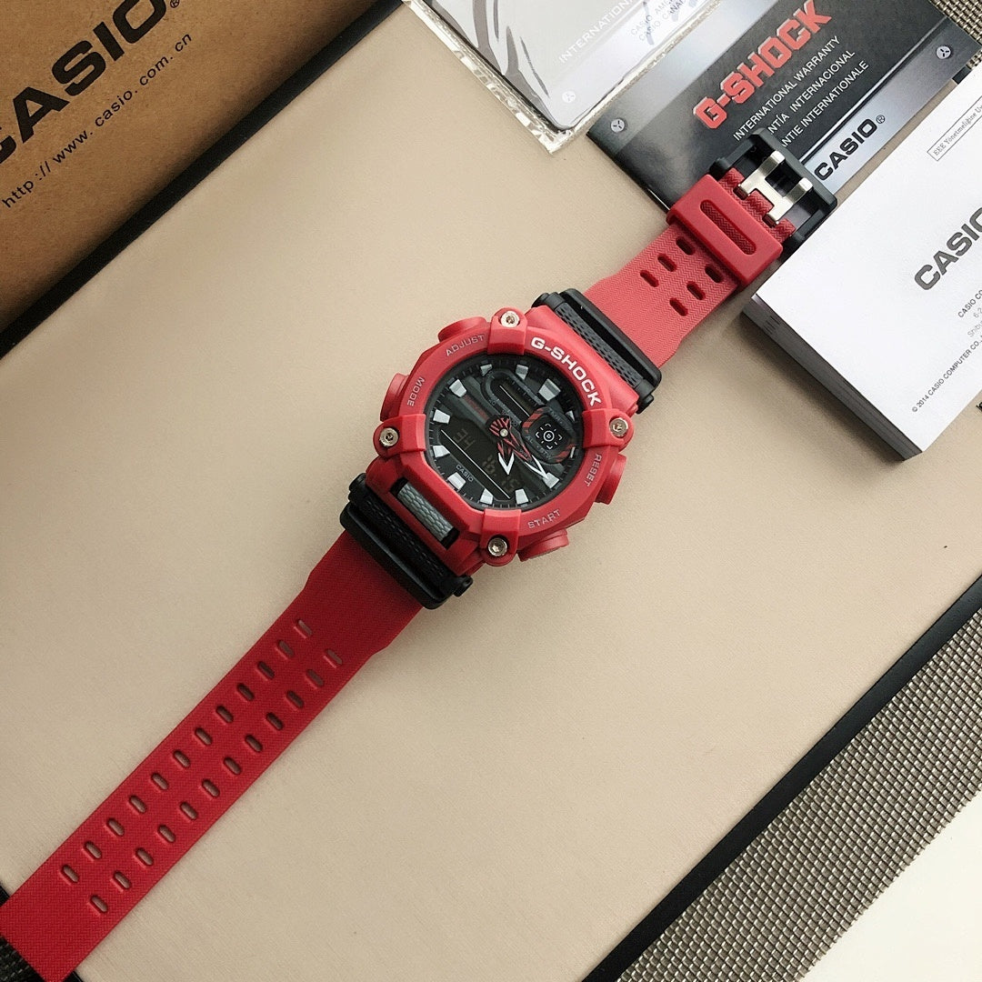 Red G-Shock wristwatch with perforated strap and round buttons on the bezel.