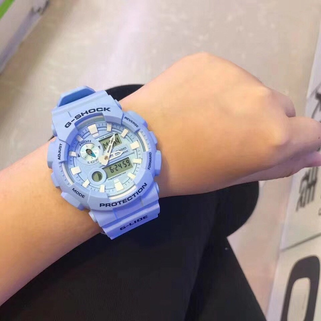 Casio G-Shock watch on wrist with light blue resin strap and round analog-digital face