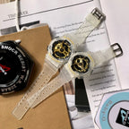 Casio watch with clear resin strap and gold skeleton dial on cardboard packaging