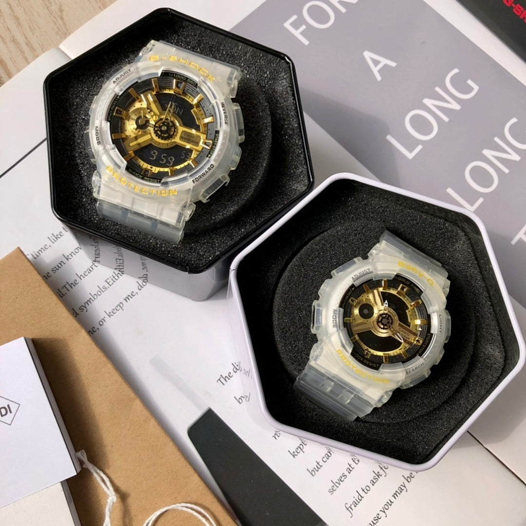 Casio watch pair in cases with clear resin straps and gold skeleton dials