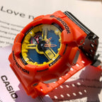 Casio G-Shock watch with orange bezel, blue dial, and black buckle on strap