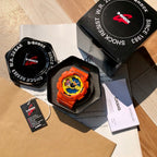 Casio G-Shock watch set in box with orange strap, tag, and paperwork