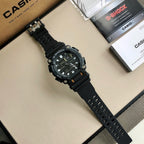 G-Shock wristwatch with black resin strap and dark dial, shown diagonally on surface