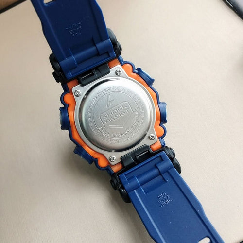 Casio G-Shock watch back case with silver cover and orange bezel, blue strap