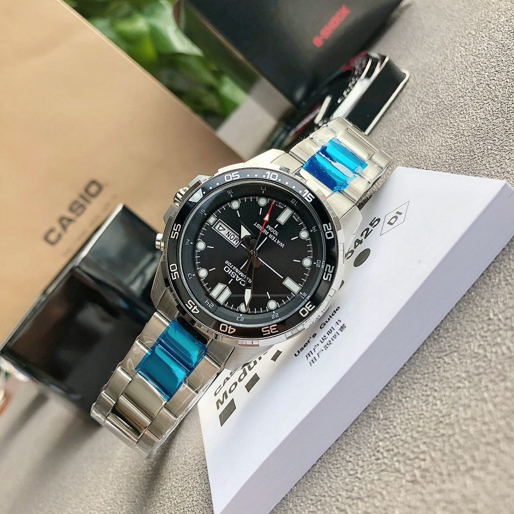 Casio watch with black dial, silver bezel, and blue strap links, on open box