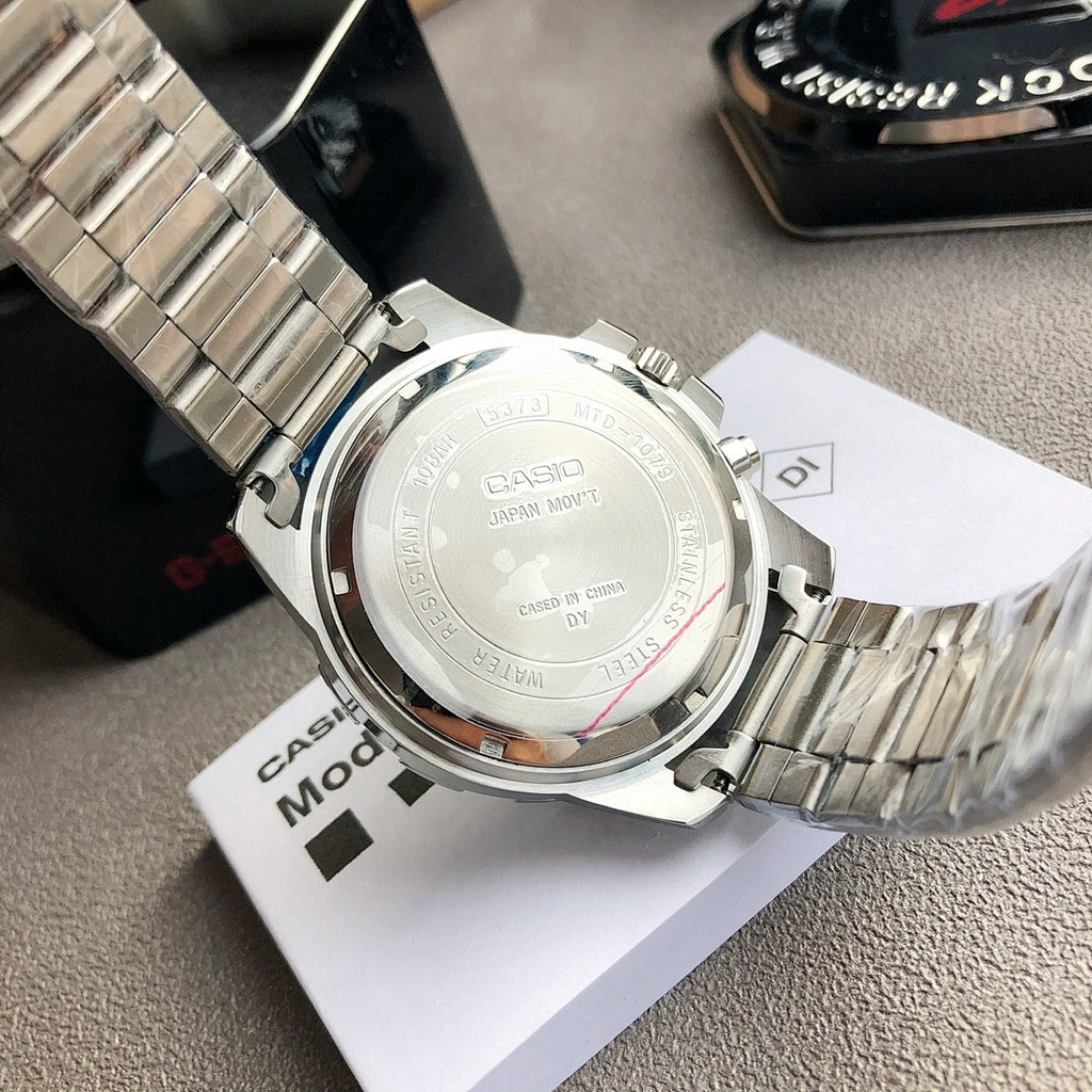 Casio watch case back with engraved markings and silver bracelet, on paperwork