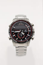 Stainless steel chronograph watch with black dial and red detailing, metal bracelet