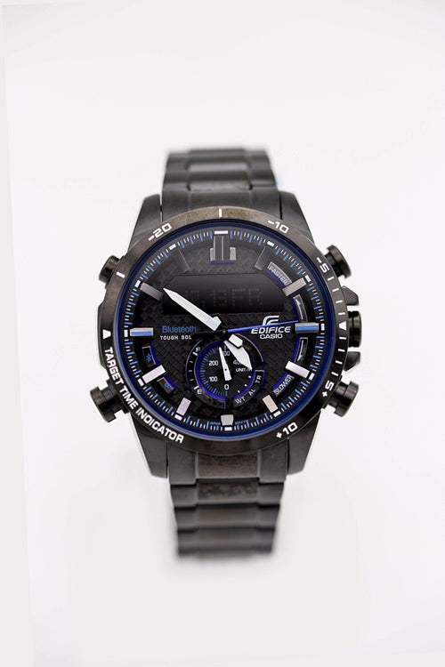 Casio watch with dark dial, blue accents, and gray metal strap