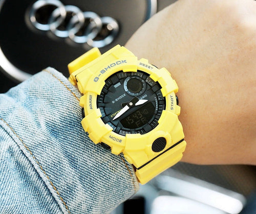 Casio watch with yellow silicone strap, black dial and round speaker detail
