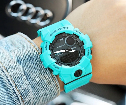 Casio watch with turquoise silicone strap, black dial and bezel accents