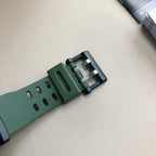 Green fabric-style watch strap with metal buckle and keeper