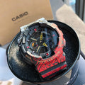 Casio G-Shock watch, red patterned resin strap, black dial with yellow hands