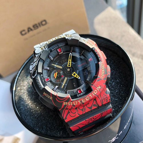 Casio G-Shock watch, red patterned resin strap, black dial with yellow hands