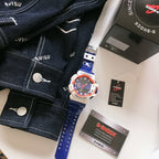 G-Shock watch with blue silicone strap, white case, orange ring around bezel