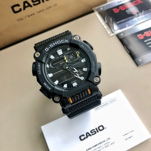 G-Shock wristwatch with black resin case and strap, black digital dial, orange accents