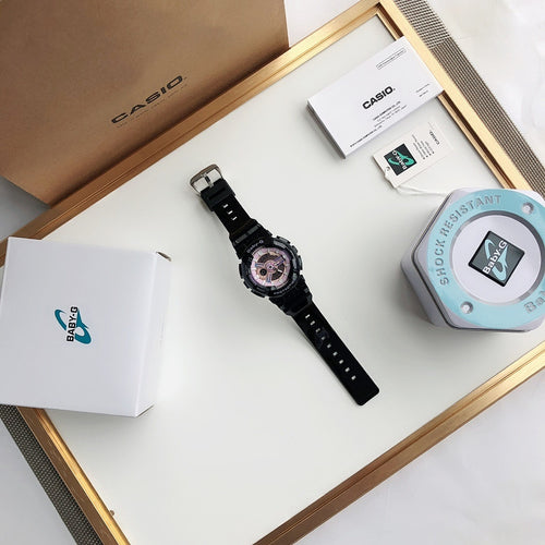 Casio wrist watch in black with round face and black strap, shown with packaging