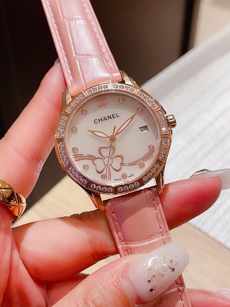 Chanel watch with light pink leather strap and diamond bezel, floral dial on hand