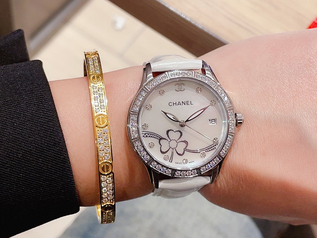 Chanel watch with silver leather strap and diamond bezel, floral dial on wrist